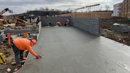 Workers smoothing concrete